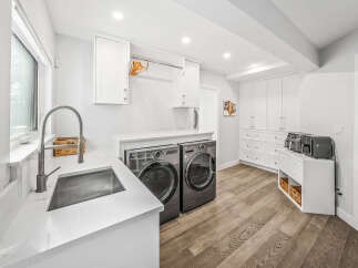 Discover this modern and spacious laundry room, featuring sleek LG front-load washer and dryer units.