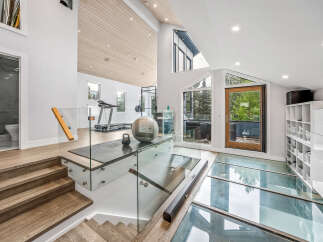 Experience modern luxury in this stunning home featuring a unique glass floor design and a spacious, open-concept living area.