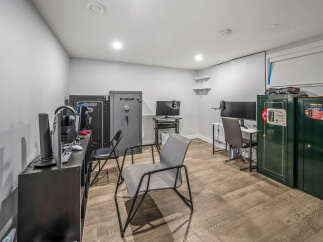 This versatile room features multiple computer workstations, perfect for a home office or gaming setup.