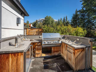 Experience the ultimate outdoor living with this stunning custom-built outdoor kitchen, perfect for entertaining.