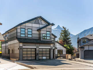 Experience modern living in this stunning multi-level home featuring a unique geometric facade and expansive glass garage doors.