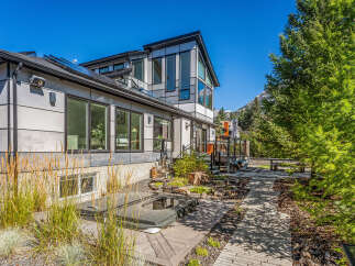Experience modern luxury in this stunning home featuring a sleek exterior and expansive windows that invite natural light.