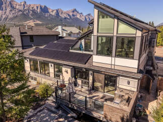 Experience modern living with this stunning home featuring a sleek architectural design and expansive windows offering breathtaking mountain views.