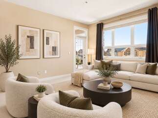 Experience modern living in this beautifully appointed living room, featuring a plush sectional sofa and comfortable accent chairs perfect for relaxation.