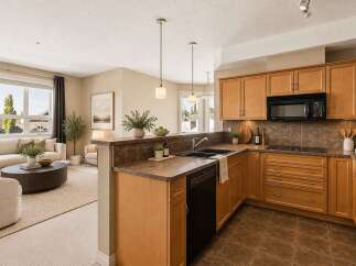 Discover this beautifully appointed kitchen featuring warm wood cabinetry and sleek granite countertops, perfect for culinary enthusiasts.