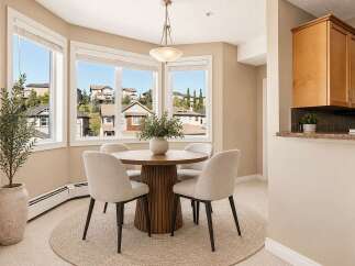 Enjoy bright and airy meals in this charming dining nook, bathed in natural light from large bay windows offering scenic views.