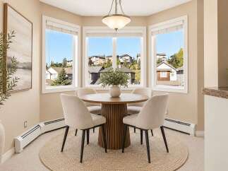 Enjoy your morning coffee in this charming breakfast nook, bathed in natural light from the large bay windows.