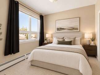 Experience comfort and style in this beautifully appointed bedroom, featuring a plush king-size bed with elegant bedding and decorative pillows.