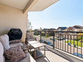 Enjoy outdoor living on this spacious balcony, perfect for entertaining or relaxing.