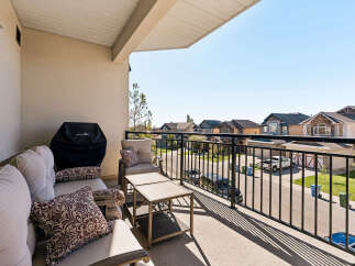 Enjoy outdoor living on this spacious balcony, perfect for entertaining or relaxing.