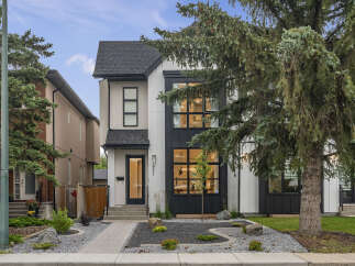 Experience modern living in this stunning new construction home, featuring a striking black and white facade and expansive windows that flood the interior with natural light.