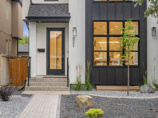 Discover modern living in this stunning home featuring a sleek black and white exterior.