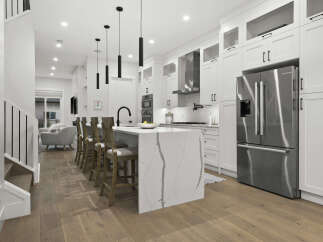 Experience modern luxury in this stunning kitchen, featuring a sleek waterfall island with marble countertops and ample seating.