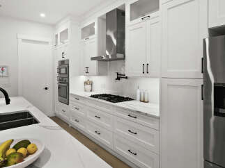 Experience modern luxury in this stunning white kitchen, featuring sleek cabinetry, a professional-grade gas range, and a double basin sink with a matte black faucet.