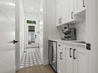 Step into this stylish entryway featuring a modern coffee bar with a sleek espresso machine and a mini-fridge, perfect for entertaining.