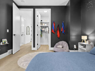 Discover this charming bedroom featuring a spacious walk-in closet and a cozy beanbag chair, perfect for relaxation.