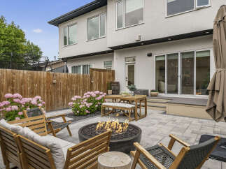 Enjoy outdoor living in this stunning backyard featuring a modern patio with a fire pit and comfortable seating.
