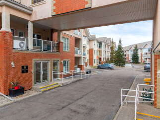 Discover comfortable living in this well-maintained apartment building, featuring a welcoming entrance with ramps and handrails for accessibility.