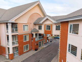 Discover modern living in this multi-story building featuring a blend of brick and stucco exteriors.