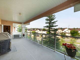 Enjoy outdoor living on this spacious balcony, perfect for entertaining or relaxing with a view.