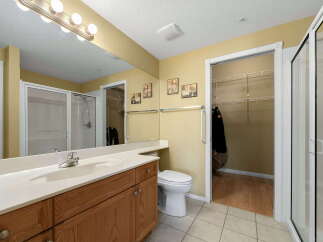 This spacious bathroom features a large vanity with ample counter space and a modern sink.