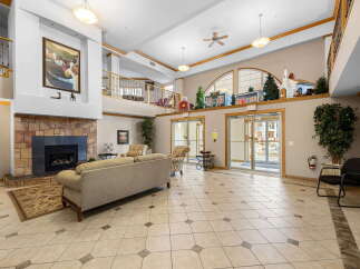Step into a grand foyer featuring a stunning stone fireplace and comfortable seating areas, perfect for relaxation and socializing.