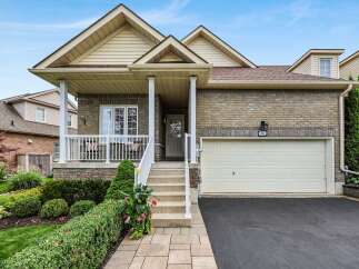 Charming brick home featuring a welcoming covered porch with seating and a bright interior.