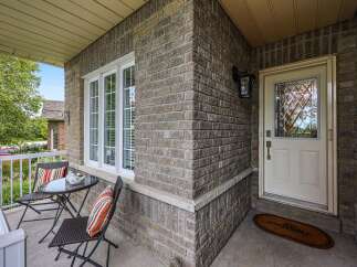 Welcome guests to this charming home with a cozy front porch featuring a bistro set perfect for morning coffee.
