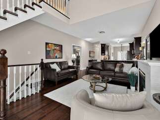 Step into this inviting living room featuring rich leather sofas and a stylish glass coffee table, perfect for entertaining.