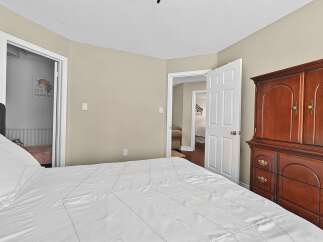Discover a charming bedroom featuring a spacious bed with crisp white linens, perfect for relaxation.