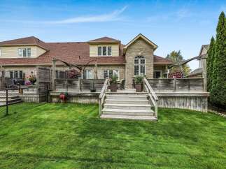 Enjoy outdoor living with this expansive wooden deck, perfect for entertaining guests or relaxing in the sun.