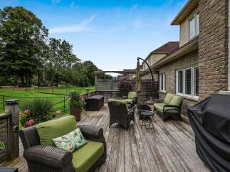 Enjoy outdoor living on this spacious wooden deck, perfect for entertaining or relaxing.