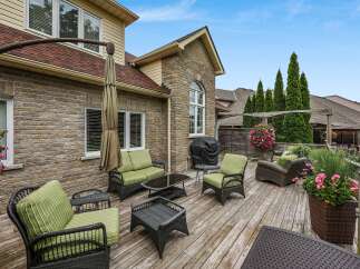 Enjoy outdoor living at its finest on this expansive wooden deck, perfect for entertaining or relaxing.
