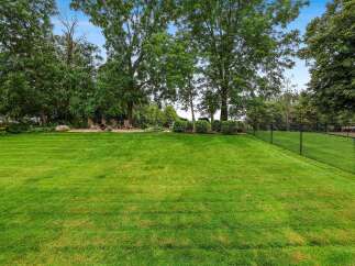 Enjoy the expansive, beautifully manicured lawn perfect for outdoor activities and gatherings.