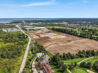 Discover this prime real estate opportunity featuring a sprawling undeveloped parcel adjacent to a picturesque golf course and a serene waterfront.