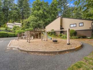 Enjoy outdoor fun at this property's charming playground, complete with a wooden fort, slide, and tire swing.