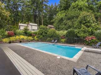 Enjoy a refreshing dip in this stunning community pool, surrounded by lush greenery and mature trees.