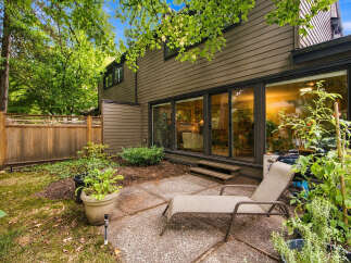 Enjoy outdoor living in this charming backyard featuring a spacious patio perfect for entertaining.