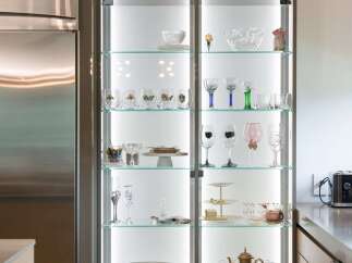 Showcase your fine china and glassware in this elegant illuminated display cabinet, perfect for a modern kitchen or dining area.