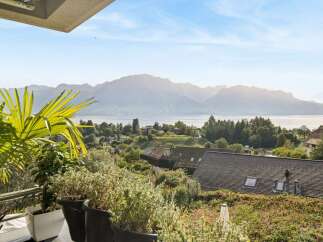 Experience breathtaking panoramic views of the lake and mountains from this stunning property.
