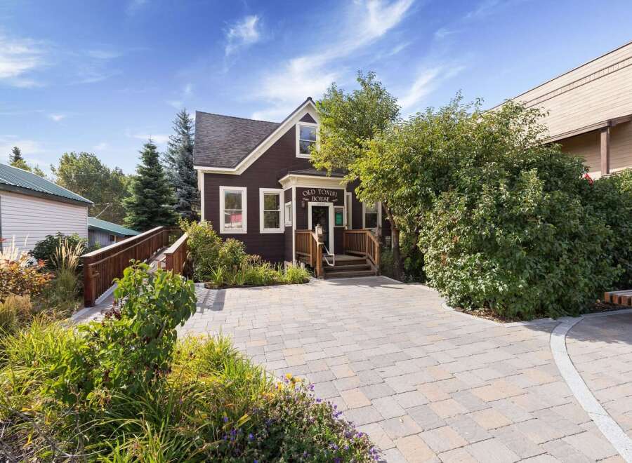 Discover the charm of the Old Tonini House, a beautifully maintained property featuring a welcoming entrance with a ramp and stairs.