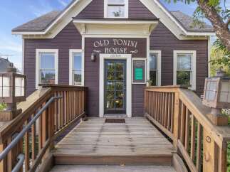 Step into the historic charm of the Old Tonini House, a beautifully preserved property offering a unique blend of vintage character and modern potential.
