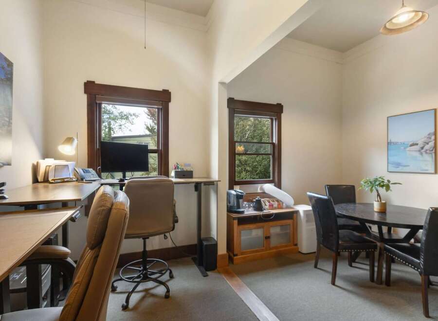 This versatile room features a dedicated workspace with a standing desk and office chair, perfect for remote work or study.