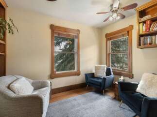 This cozy living space features two comfortable armchairs and a plush sofa, perfect for relaxation.