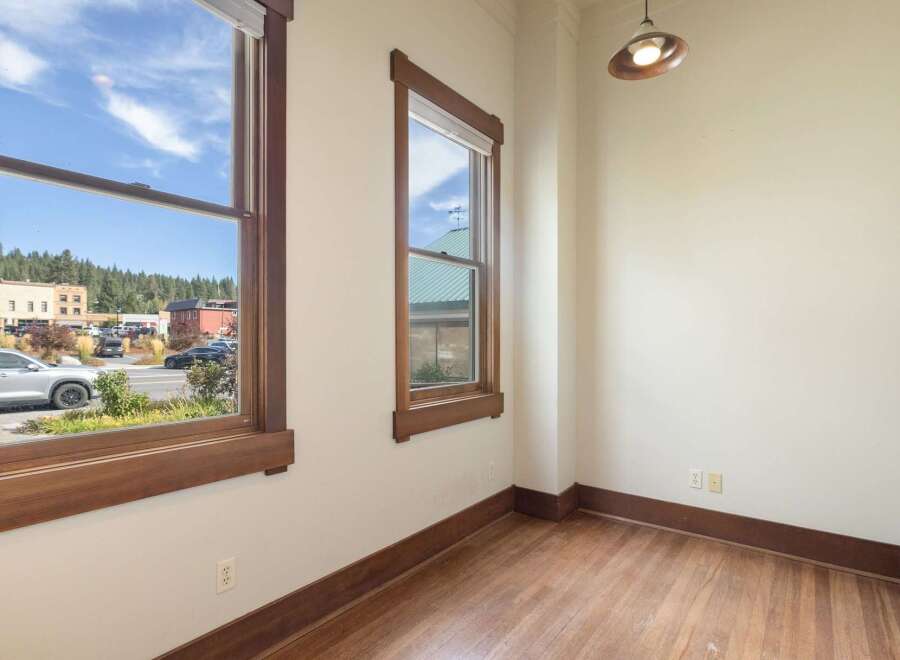 Experience the charm of this interior space featuring beautiful hardwood floors and large windows that flood the room with natural light.
