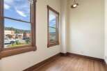 Experience the charm of this interior space featuring beautiful hardwood floors and large windows that flood the room with natural light.