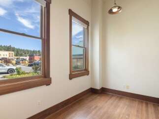 Experience the charm of this interior space featuring beautiful hardwood floors and large windows that flood the room with natural light.