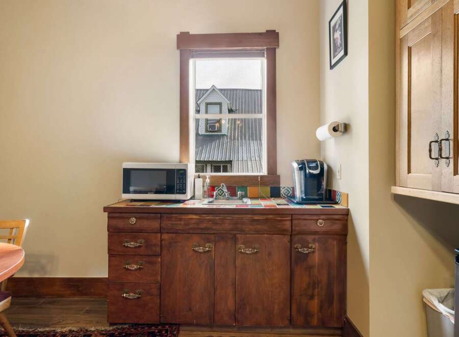 This charming kitchenette features a microwave and a Keurig coffee maker, perfect for preparing quick meals and enjoying your morning brew.