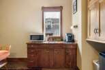 This charming kitchenette features a microwave and a Keurig coffee maker, perfect for preparing quick meals and enjoying your morning brew.
