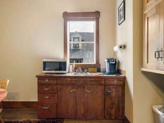 This charming kitchenette features a microwave and a Keurig coffee maker, perfect for preparing quick meals and enjoying your morning brew.